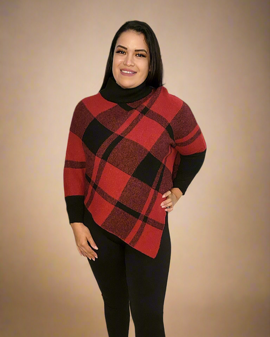 Woman wearing a red and black plaid sweater with black pants on a beige background