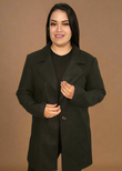 Woman wearing a black coat against a brown background