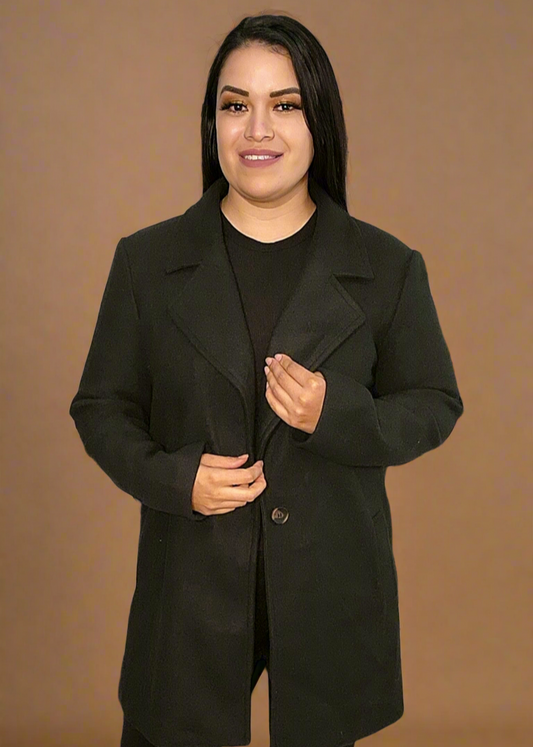 Woman wearing a black coat against a brown background