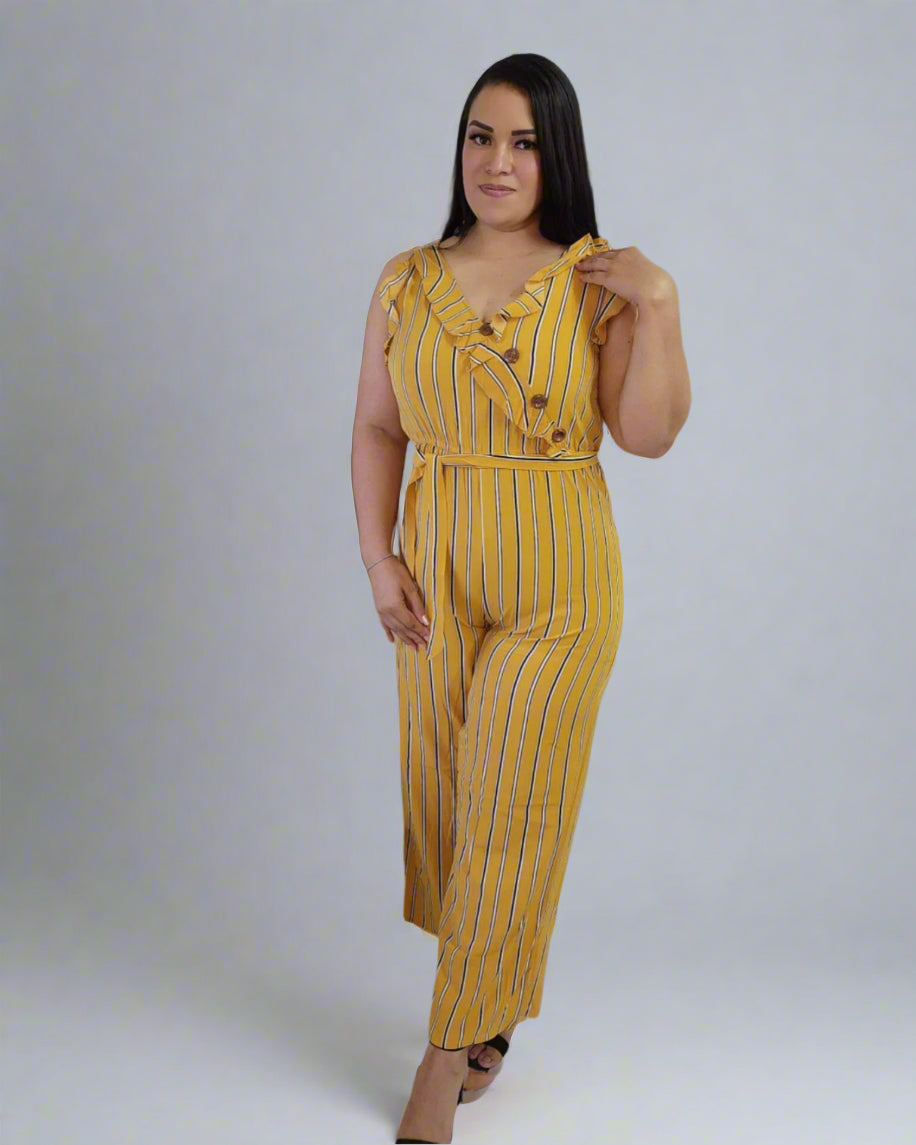 Woman wearing a yellow striped jumpsuit on a plain background