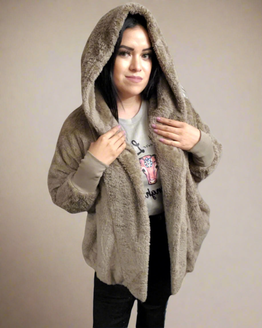 Woman wearing a beige hooded jacket on a white background