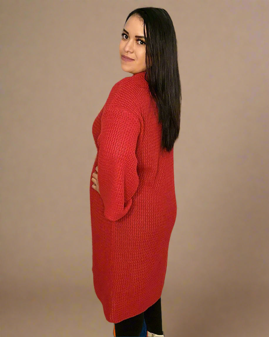 Woman wearing a red knitted dress against a beige background