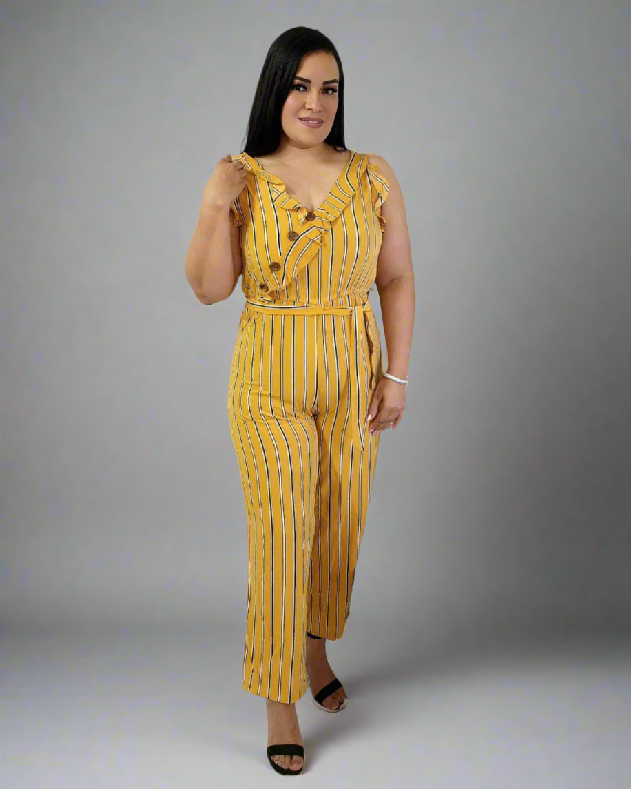 Woman wearing a yellow striped jumpsuit on a gray background