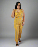 Woman wearing a yellow striped jumpsuit on a gray background